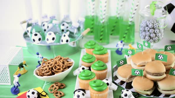 Kids football party set with snacks and drinks.