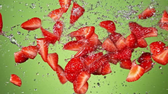 Super Slow Motion Shot of Fresh Strawberries and Water Side Collision on Green at 1000Fps