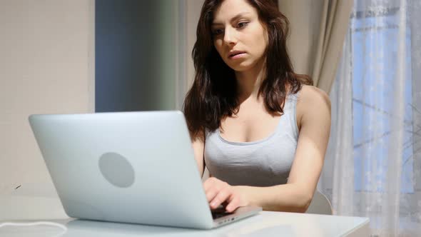 Young Woman Working on Laptop at Night