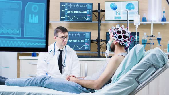 Doctor in a Modern Neurology Centre Talking with His Patient