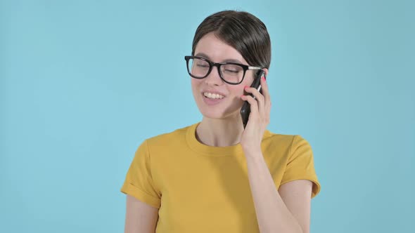 Happy Young Woman Speaking on Phone on Purple Background