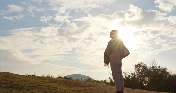 Woman look at the view at sunset time in countryside