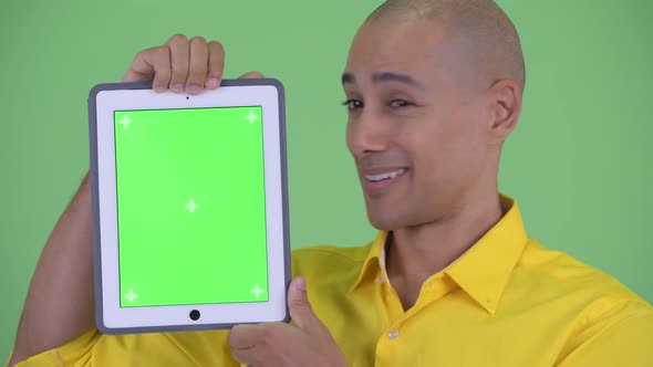 Face of Happy Handsome Bald Businessman Showing Digital Tablet