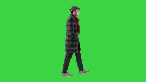 Gentleman Wearing a Protective Face Mask Walking on a Green Screen, Chroma Key.