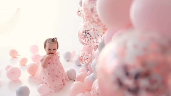 Little Cute Girl Smiling with Colorful Balloons White and Pink in Birthday Decoration