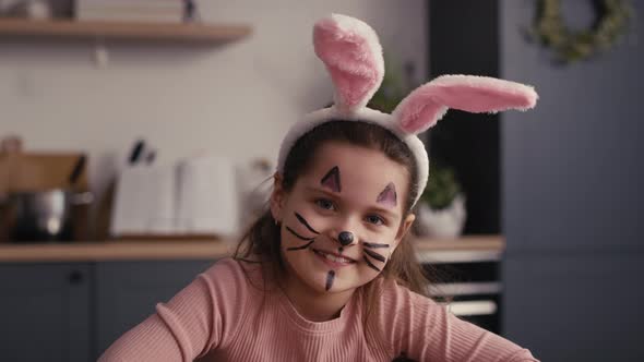 Portrait of caucasian girl with painter easter bunny on face. Shot with RED helium camera in 8K