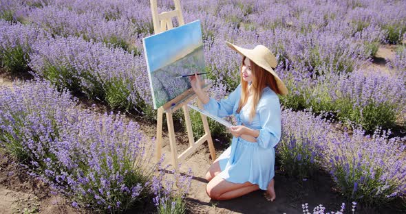 a Young Artist Paints a Picture in a Lavender Field