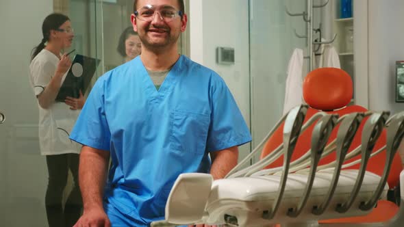 Portrait of Smiling Man Nurse in Dental Office