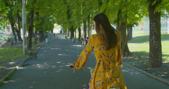 Cycling In City Park. Pretty Lady Moving On Bicycle. Cyclist Girl Workout Riding On Bicycle In