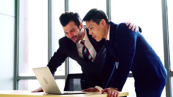 Two Happy Business People Celebrate at Office