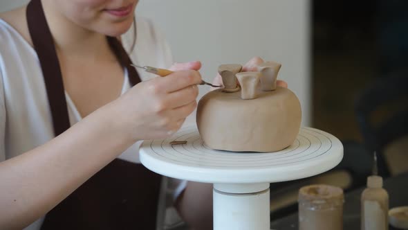 Young Woman Attaching Clay Product Part To Future Ceramic Product. Pottery Workshop