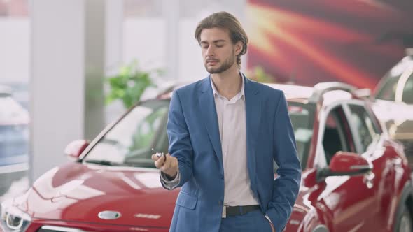 Young Successful Businessman Stretching Car Key To Camera Smiling