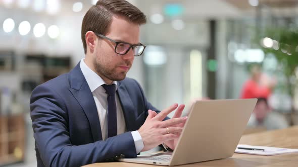 Businessman with Laptop Thinking at Work 