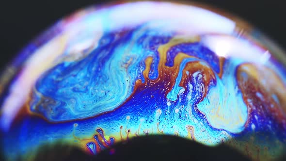 Abstract Multicolored Chaotic Swirl Texture Inside of the Soap Bubble Closeup