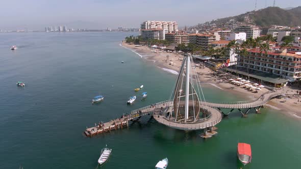 Boats Floating In The Sea Around The Muelle de Playa Los Muertos In Puerto Vallarta, Mexico. - aeria