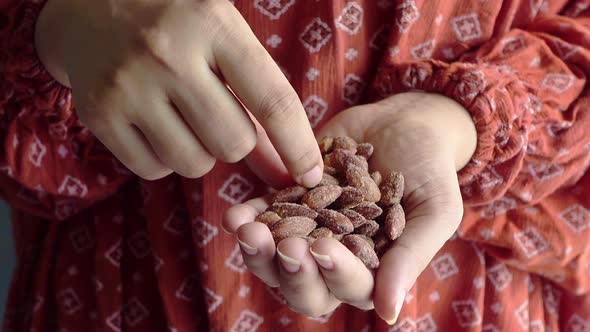 Young Women Eating Fresh Almond Close Up