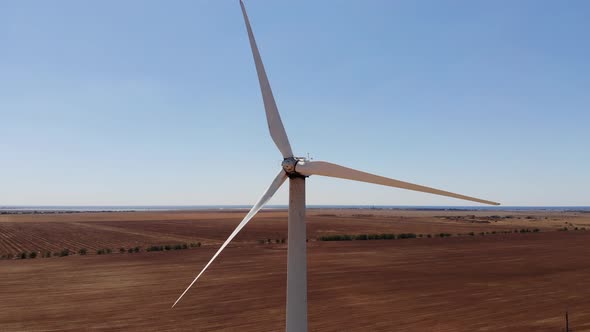 Large Wind Turbines with Blades in the Field Aerial View Drone Turn