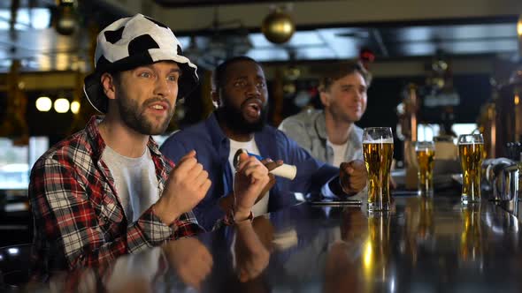 Football Fans Watching Match in Pub, Frustrated With Missed Goal, Losing Game