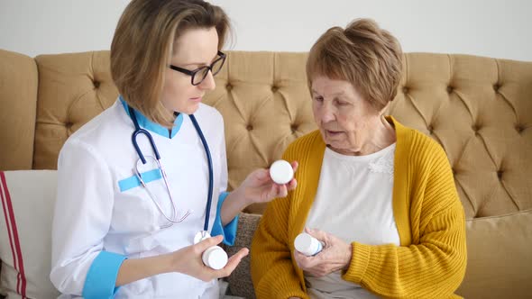 Female Doctor Prescribing Medicine To Elderly Woman.