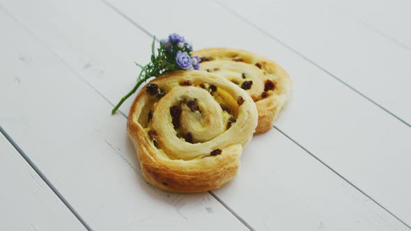 Delicious Pastry with Raisins on White Wooden Table