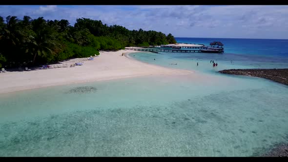 Aerial top down tourism of relaxing tourist beach break by blue green ocean with white sandy backgro