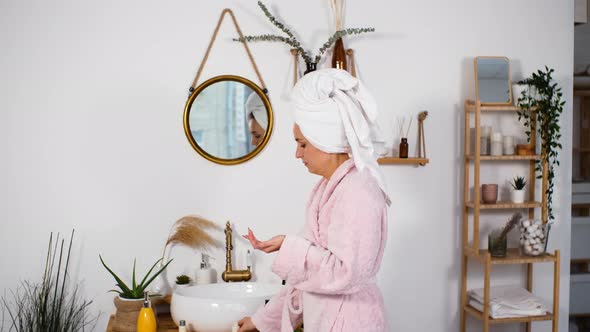 Female Applying Hand Creme After Taking Shower