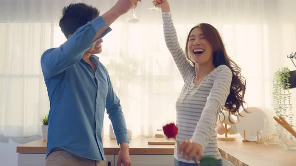 Asian young couple clinking glass of wine and drink on valentine's day.