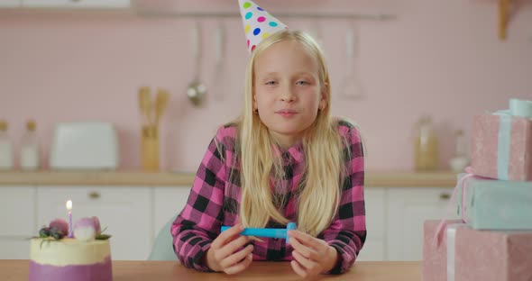 Cute Blonde Girl in Birthday Hat Congratulating Looking at Camera. Webcam View of Child Speaking