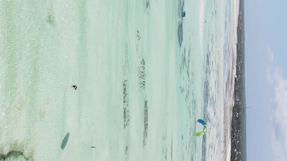 Vertical Video Kitesurfing Near the Shore of Zanzibar Tanzania Aerial View