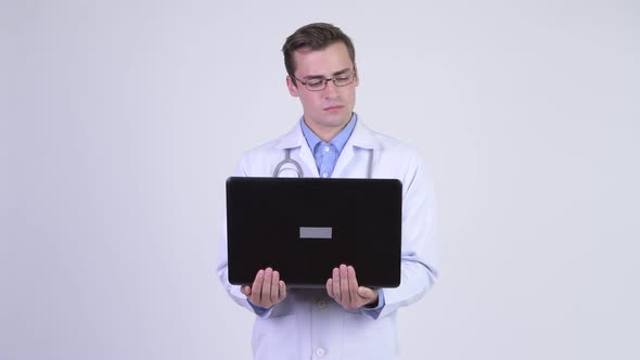 Young Happy Handsome Man Doctor Using Laptop