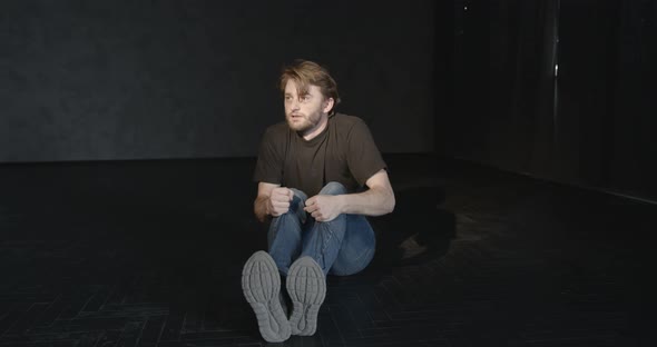 Desperate Young Drug Addict Sitting Alone in Dark