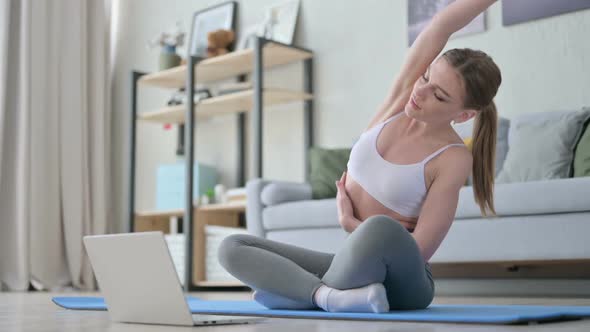 Woman Doing Yoga While on Video Call on Laptop