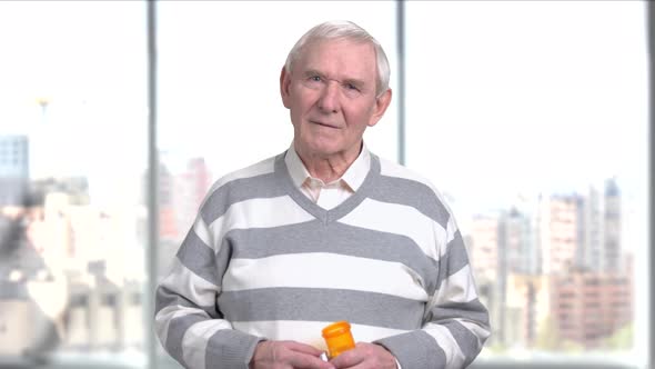 Elderly Man with a Bottle of Pills.