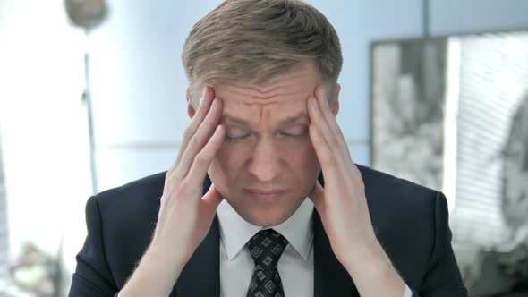 Headache Tense Businessman with Head Pain