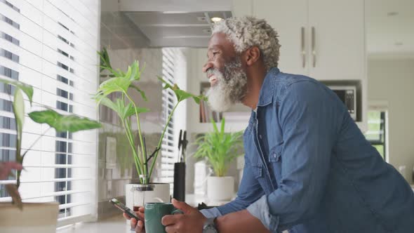 Video of african american senior man drinking coffee