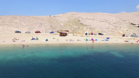 Aerial view of tourists on isolated beach of Pag island, Croatia