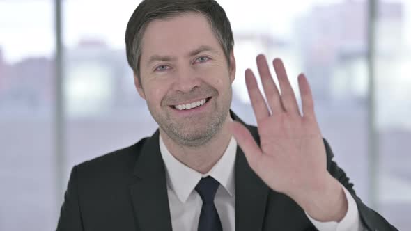 Portrait of Cheerful Middle Aged Businessman Doing Video Chat 