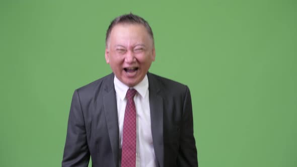 Mature Japanese Businessman Laughing Out Loud