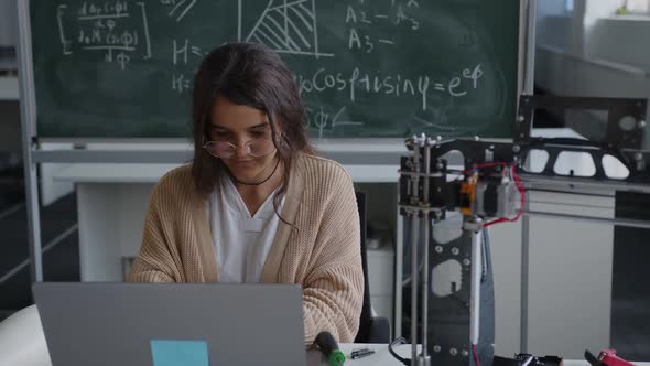 Girl in School Laboratory Types on the Grey Laptop