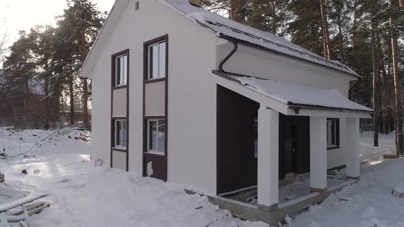 Drone shot of new white modern residential house at winter 01