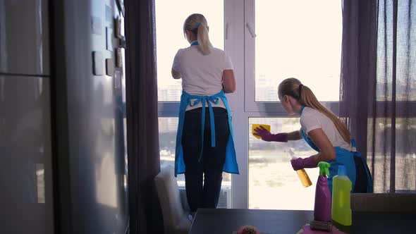 Cleaning Service Staff Washing Window in Apartment