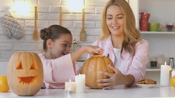 Daughter and Mother Carving Pumpkin Jack-O-Lantern, Spending Time Together