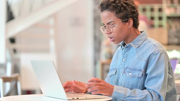 Loss African Woman Reacting to Failure on Laptop at Cafe