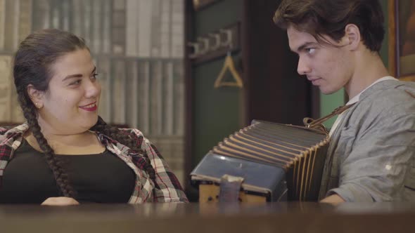 Skill Young Man Playing the Accordion for a Cute Fat Girl