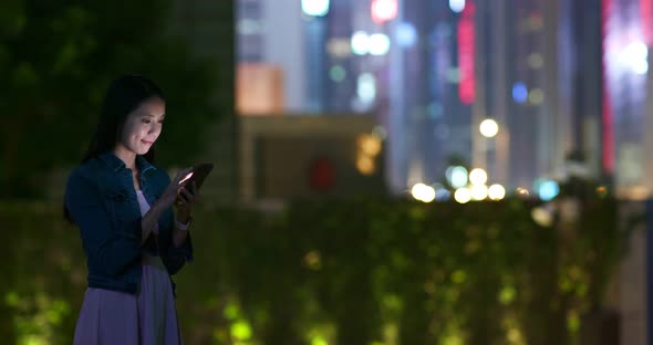 Woman Use of Mobile Phone in City at Night