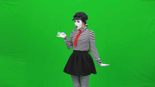 Mime Girl Has Found Dandelion, Blowing on It. Chroma Key