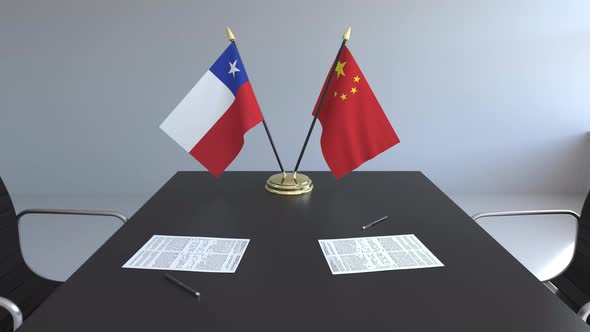 Flags of Chile and China and Papers on the Table alt