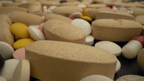 Pills in Medical Lab Moving Slowly Over Them in Close Up View