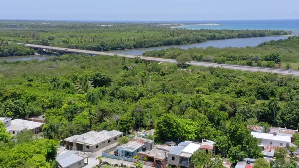 Bridge crossing Soco river, San Pedro de Macoris in Dominican Republic. Aerial forward