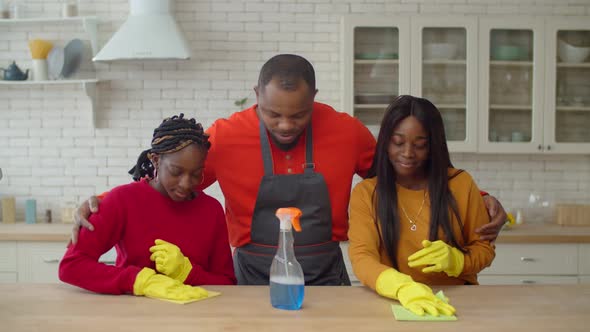 Proud Black Dad Encouraging Daughters to Do Housework